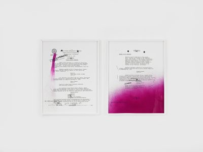 Two pieces of paper with type-writing (archival FBI documents on Rodney Barnette) sit side by side against a white backdrop. Portions of the papers are covered with glitter and purple spray paint.